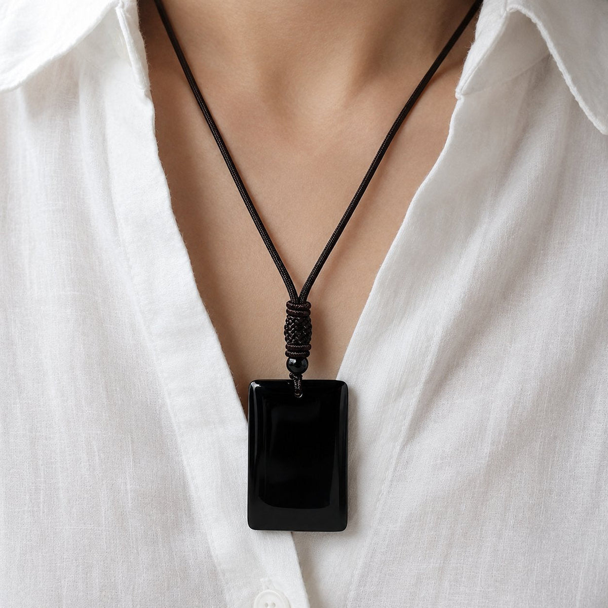 Black obsidian pendant worn on a long cord