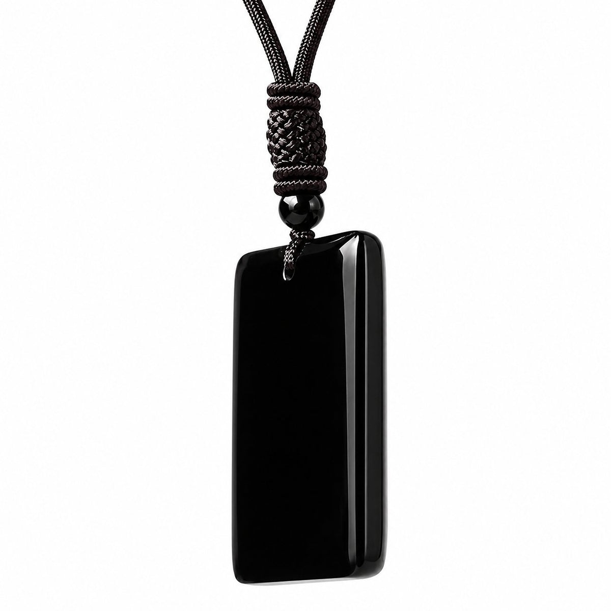 Side profile of black obsidian pendant showing thickness