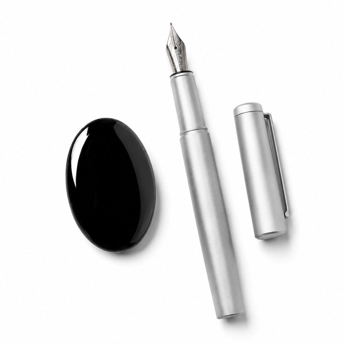 Compact black obsidian palm stone for hand-held use