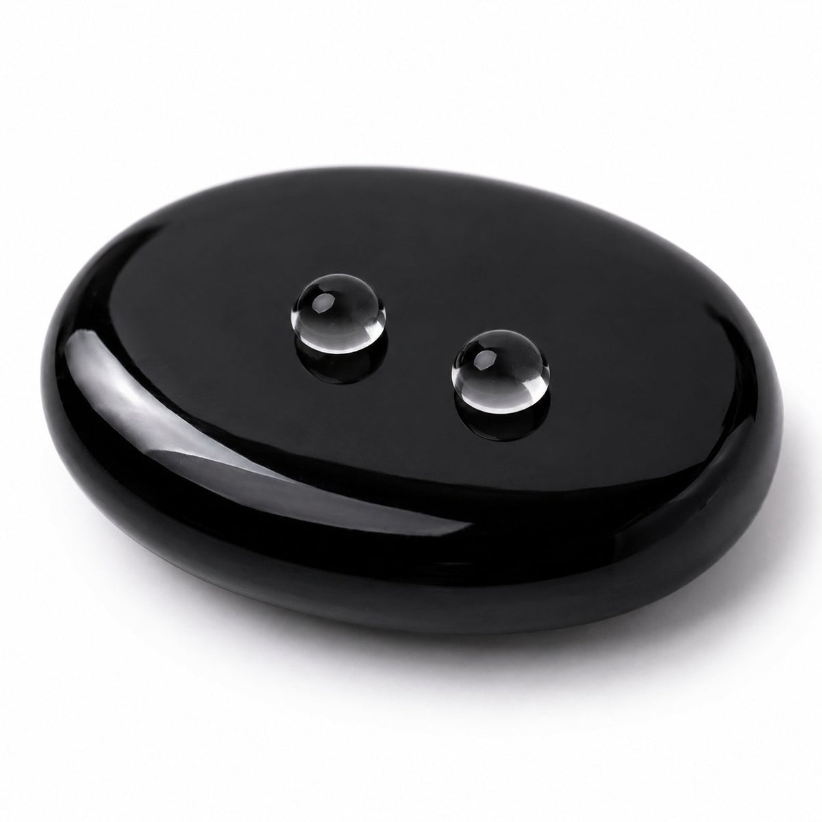 Water droplets on a polished black obsidian palm stone