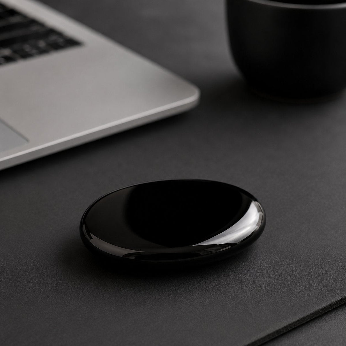Black obsidian palm stone on an office desk
